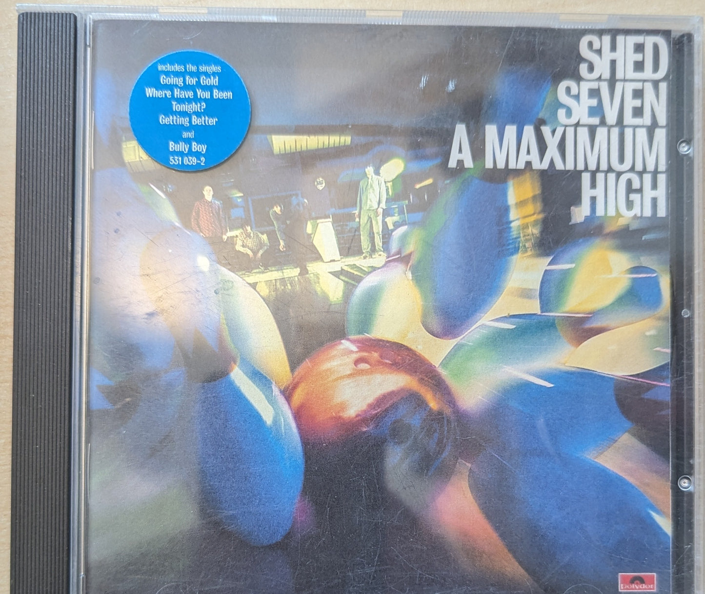 CD cover of 'A Maximum High' by Shed Seven with colorful bowling ball design.
