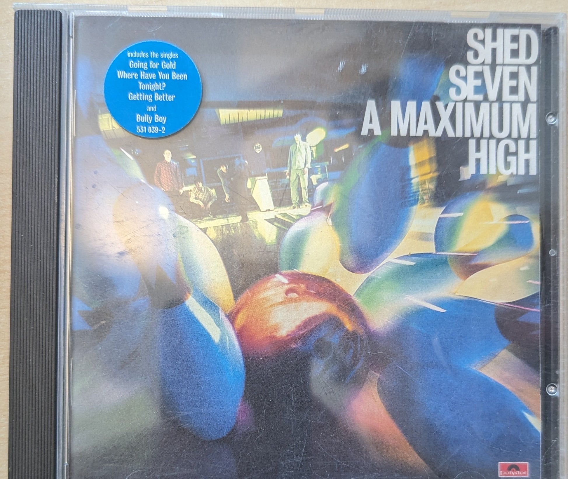 CD cover of 'A Maximum High' by Shed Seven with colorful bowling ball design.